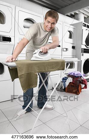 Man ironing a t-shirt View Large Photo Image Stock Photograph - Man ironing a t-shirt. Fotosearch