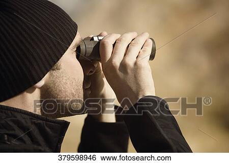 Man looking through binoculars, Mammoth Hot Springs, Yellowstone National Park, Wyoming, USA View Large Photo Image Stock Photograph - Man looking through binoculars, Mammoth Hot Springs, Yellowstone National Park, Wyoming, USA. Fotosearch