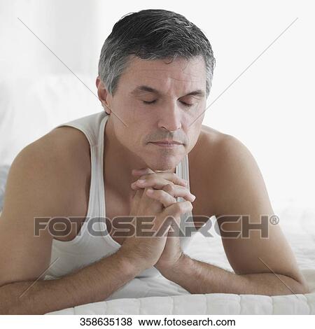 Man lying on the bed and thinking View Large Photo Image Stock Photo - Man lying on the bed and thinking. Fotosearch