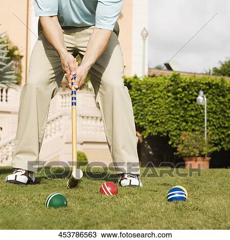 Stock Image - Man playing croquet in a hotel lawn, Biltmore Hotel, Coral Gables, Florida, USA. Fotosearch