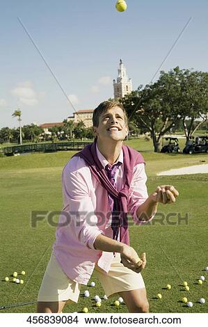 Man playing with golf ball in a golf course, Biltmore Golf Course, Coral Gables, Florida, USA View Large Photo Image Picture - Man playing with golf ball in a golf course, Biltmore Golf Course, Coral Gables, Florida, USA. Fotosearch