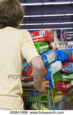 Man pushing a shopping cart View Large Photo Image Stock Photo - Man pushing a shopping cart. Fotosearch