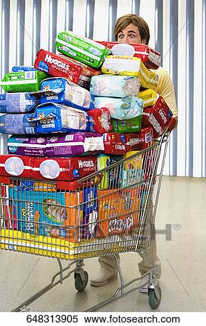 Man pushing a shopping cart View Large Photo Image Stock Photography - Man pushing a shopping cart. Fotosearch