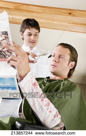 Man receiving a haircut in a salon View Large Photo Image Picture - Man receiving a haircut in a salon. Fotosearch