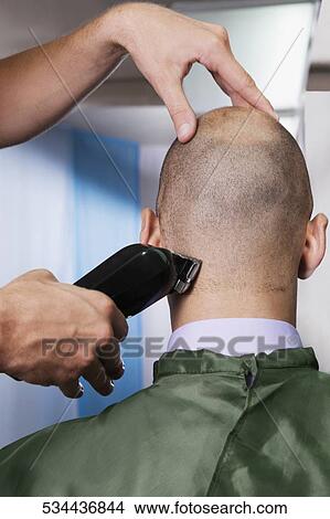 Man receiving a haircut in a salon View Large Photo Image Picture - Man receiving a haircut in a salon. Fotosearch