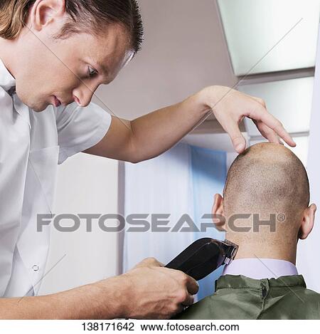Man receiving a haircut in a salon View Large Photo Image Stock Image - Man receiving a haircut in a salon. Fotosearch