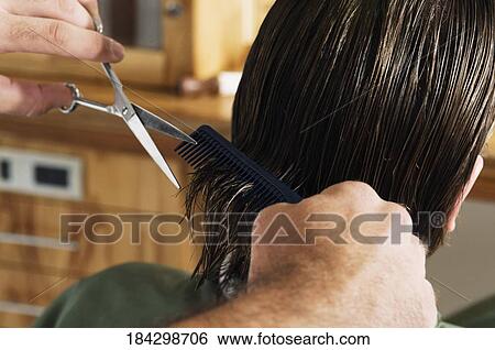 Man receiving a haircut in a salon View Large Photo Image Stock Photograph - Man receiving a haircut in a salon. Fotosearch