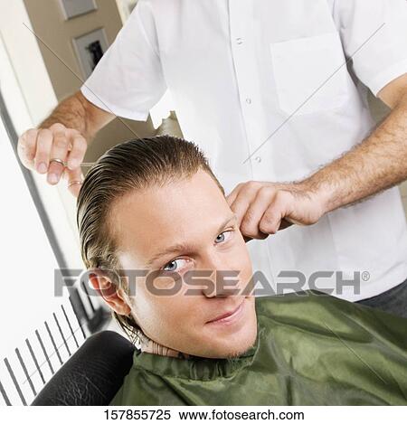 Man receiving a haircut in a salon View Large Photo Image Stock Photography - Man receiving a haircut in a salon. Fotosearch