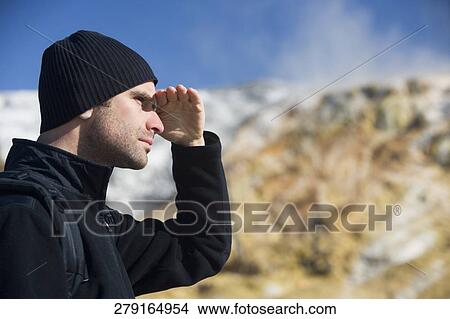 Picture - Man shielding his eyes, Mammoth Hot Springs, Yellowstone National Park, Wyoming, USA. Fotosearch
