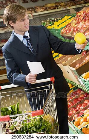 Man shopping in a supermarket View Large Photo Image Picture - Man shopping in a supermarket. Fotosearch