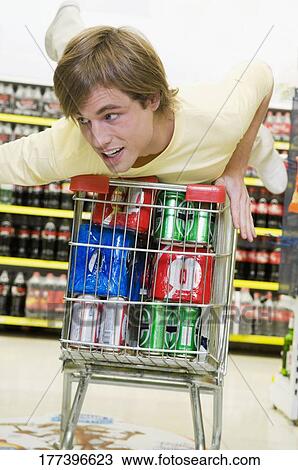 Man shopping in a supermarket View Large Photo Image Stock Image - Man shopping in a supermarket. Fotosearch
