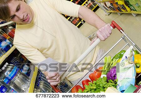 Stock Image - Man shopping in a supermarket. Fotosearch
