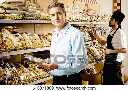 Stock Photo - Man shopping in a supermarket. Fotosearch