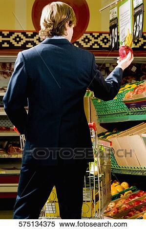 Man shopping in a supermarket View Large Photo Image Stock Photography - Man shopping in a supermarket. Fotosearch