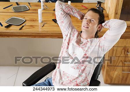 Man sitting in a salon View Large Photo Image Stock Image - Man sitting in a salon. Fotosearch