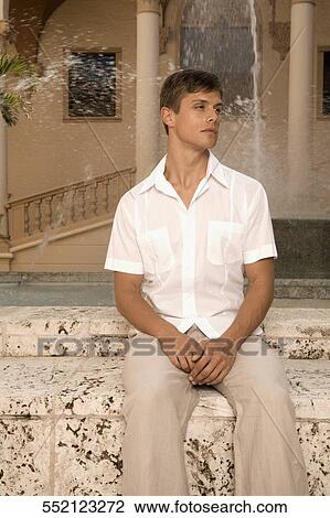 Stock Image - Man sitting in front of a fountain, Biltmore Hotel, Coral Gables, Florida, USA. Fotosearch