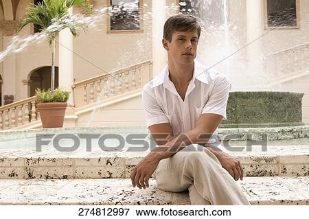 Man sitting in front of a fountain, Biltmore Hotel, Coral Gables, Florida, USA View Large Photo Image Stock Photo - Man sitting in front of a fountain, Biltmore Hotel, Coral Gables, Florida, USA. Fotosearch