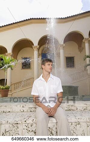 Man sitting in front of a fountain, Biltmore Hotel, Coral Gables, Florida, USA View Large Photo Image Stock Photograph - Man sitting in front of a fountain, Biltmore Hotel, Coral Gables, Florida, USA. Fotosearch