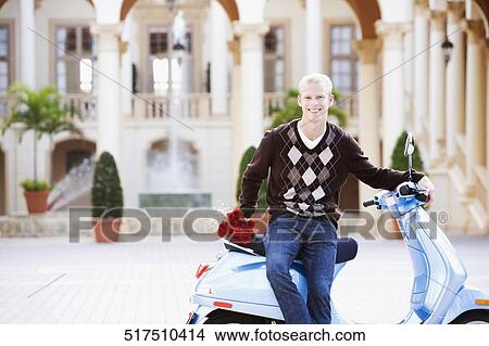 Man sitting on a moped and smiling, Biltmore Hotel, Coral Gables, Florida, USA View Large Photo Image Picture - Man sitting on a moped and smiling, Biltmore Hotel, Coral Gables, Florida, USA. Fotosearch