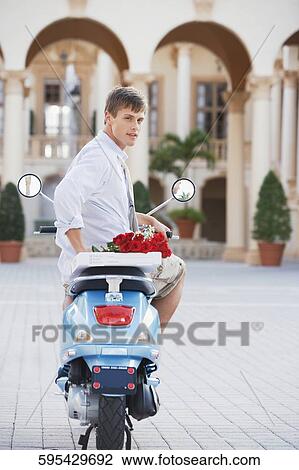 Man sitting on a moped, Biltmore Hotel, Coral Gables, Florida, USA View Large Photo Image Stock Image - Man sitting on a moped, Biltmore Hotel, Coral Gables, Florida, USA. Fotosearch