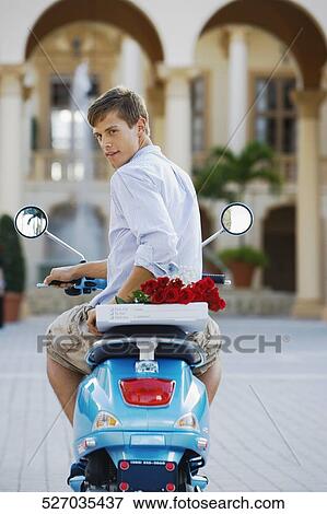 Man sitting on a moped, Biltmore Hotel, Coral Gables, Florida, USA View Large Photo Image Stock Photo - Man sitting on a moped, Biltmore Hotel, Coral Gables, Florida, USA. Fotosearch
