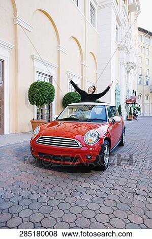 Man standing in a car with his arms raised, Biltmore Hotel, Coral Gables, Florida, USA View Large Photo Image Stock Photo - Man standing in a car with his arms raised, Biltmore Hotel, Coral Gables, Florida, USA. Fotosearch
