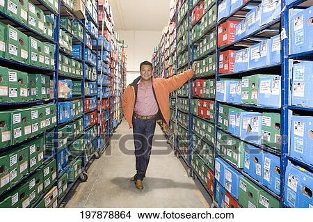 Man standing in a warehouse, Miami, Florida, USA View Large Photo Image Picture - Man standing in a warehouse, Miami, Florida, USA. Fotosearch