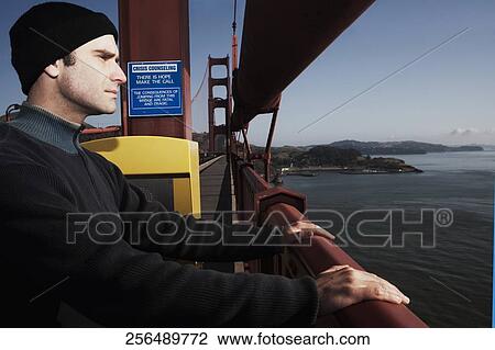 Man standing on a bridge, Golden Gate Bridge, San Francisco Bay, San Francisco, California, USA View Large Photo Image Stock Image - Man standing on a bridge, Golden Gate Bridge, San Francisco Bay, San Francisco, California, USA. Fotosearch