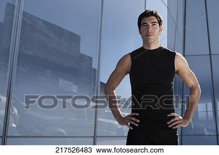Man standing with arms akimbo View Large Photo Image Stock Image - Man standing with arms akimbo. Fotosearch