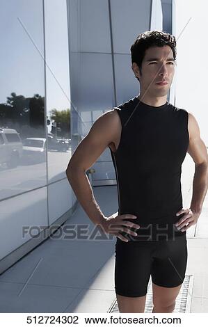Man standing with arms akimbo View Large Photo Image Stock Image - Man standing with arms akimbo. Fotosearch