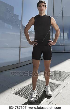 Man standing with arms akimbo View Large Photo Image Stock Photo - Man standing with arms akimbo. Fotosearch