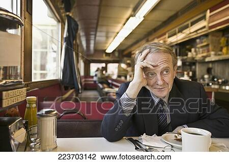 Man thinking in a restaurant View Large Photo Image Stock Image - Man thinking in a restaurant. Fotosearch
