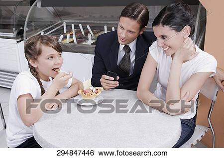 Man with a teenage girl and a girl in an ice cream parlor View Large Photo Image Stock Photograph - Man with a teenage girl and a girl in an ice cream parlor. Fotosearch