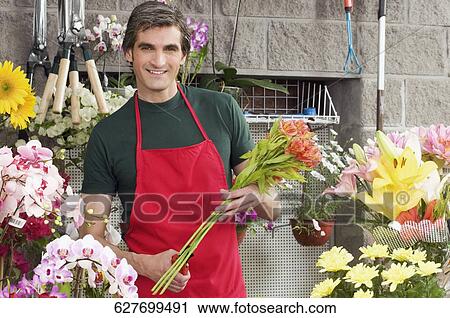 Man working in a flower shop View Large Photo Image Stock Image - Man working in a flower shop. Fotosearch