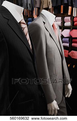 Stock Image - Mannequins dressed in formalwear in a clothing store. Fotosearch