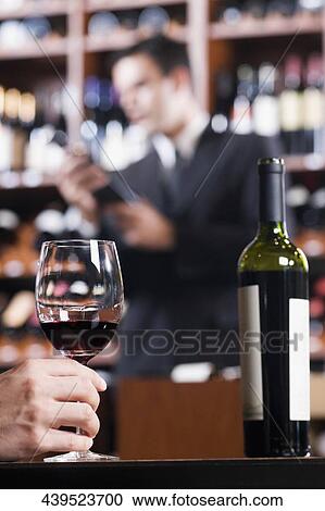 Man's hand holding a wine glass View Large Photo Image Stock Image - Man's hand holding a wine glass. Fotosearch
