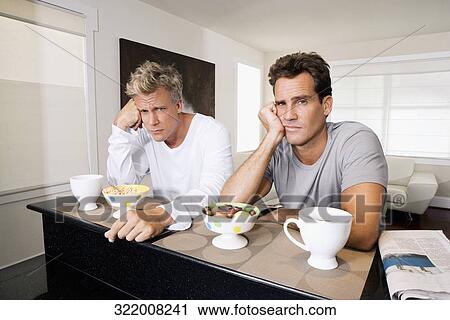 Men frowning at bowls of cereal and fruits View Large Photo Image Stock Image - Men frowning at bowls of cereal and fruits. Fotosearch
