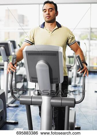 Mid adult man exercising on a treadmill in a gym View Large Photo Image Stock Photograph - Mid adult man exercising on a treadmill in a gym. Fotosearch