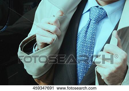 Mid section view of a businessman wearing an overcoat View Large Photo Image Stock Image - Mid section view of a businessman wearing an overcoat. Fotosearch
