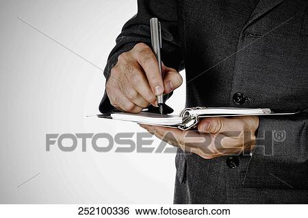 Mid section view of a businessman writing on a spiral notebook View Large Photo Image Stock Photograph - Mid section view of a businessman writing on a spiral notebook. Fotosearch
