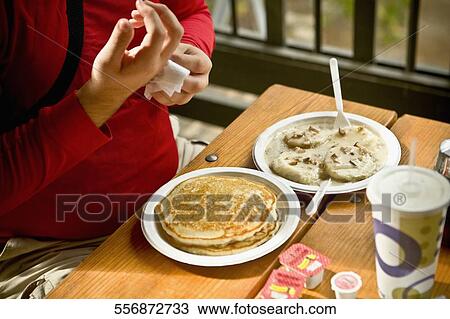 Mid section view of a man using a napkin View Large Photo Image Stock Image - Mid section view of a man using a napkin. Fotosearch