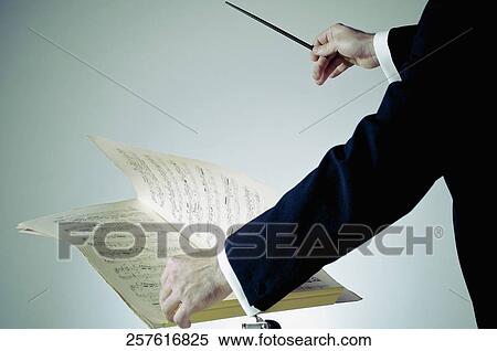 Stock Photography - Mid section view of a music conductor performing. Fotosearch