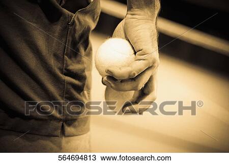 Mid section view of a person holding a tennis ball View Large Photo Image Stock Image - Mid section view of a person holding a tennis ball. Fotosearch