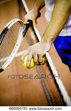 Mid section view of a person holding a tennis racket and tennis balls View Large Photo Image Stock Image - Mid section view of a person holding a tennis racket and tennis balls. Fotosearch