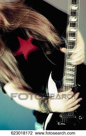 Mid section view of a person playing a guitar View Large Photo Image Stock Image - Mid section view of a person playing a guitar. Fotosearch