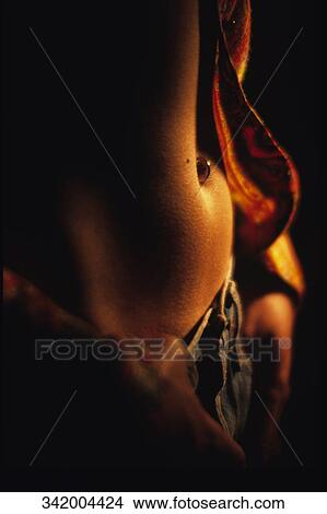 Picture - Mid section view of a person wearing jeans. Fotosearch