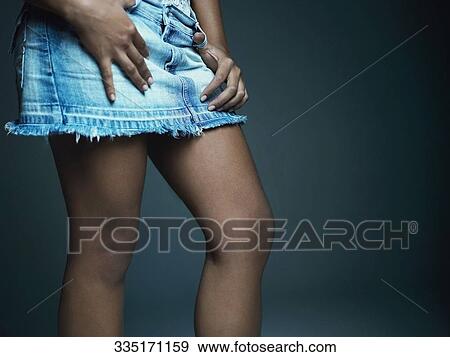 Mid section view of a woman wearing a skirt View Large Photo Image Stock Photo - Mid section view of a woman wearing a skirt. Fotosearch