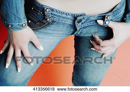 Mid section view of a woman wearing jeans View Large Photo Image Stock Photo - Mid section view of a woman wearing jeans. Fotosearch