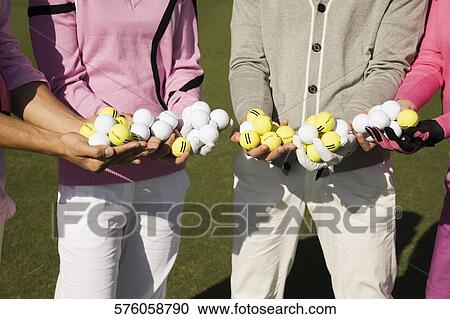 Mid section view of four friends holding golf balls, Biltmore Golf Course, Coral Gables, Florida, USA View Large Photo Image Stock Image - Mid section view of four friends holding golf balls, Biltmore Golf Course, Coral Gables, Florida, USA. Fotosearch