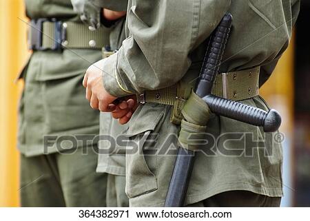 Mid section view of three policemen standing in a row View Large Photo Image Stock Image - Mid section view of three policemen standing in a row. Fotosearch